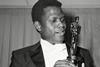 Sidney Poitier is photographed with his Oscar statuette