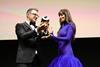 Dakota Johnson receiving the Golden Eye Award from ZFF's Christian Jungen