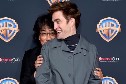 Bong Joon-ho and Robert Pattinson at the Warner Bros presentation at CinemaCon 2024.