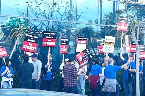 Picket lines are stretched around Hollywood blocks as the WGA strikes begins