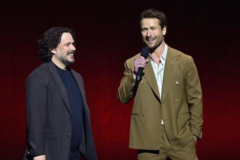 Edgar Wright and Glen Powell promoting 'The Running Man' onstage at Paramount's CinemaCon presentation.