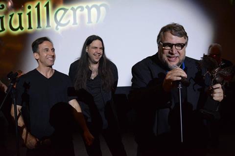 Fantasia co-director Mitch Davis and programmer Tony Timpone present Guillermo del Toro with the Cheval Noir Award in 2016