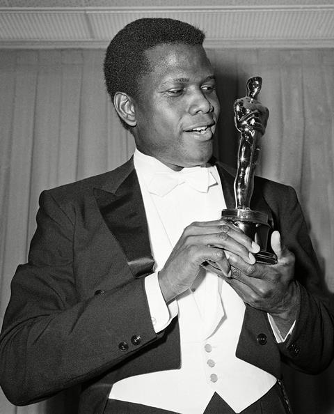 Sidney Poitier is photographed with his Oscar statuette 