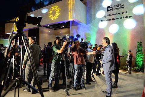 Hanna Attalah being interviewed in front of Ramallah Cultural Palace