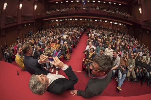 Thes Director Alexander Payne takes photo of TIFF's audience in the Olympion