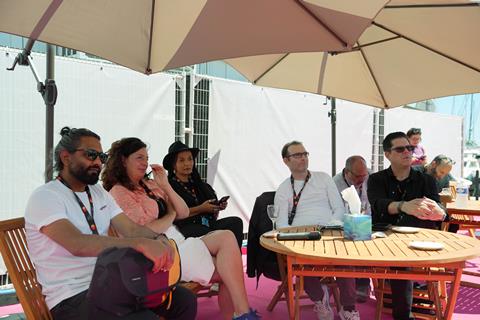 Attendees watch the Olivewood Studios panel at Cannes