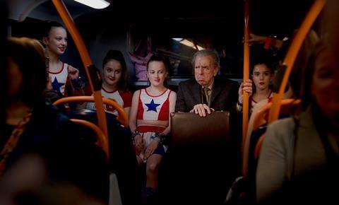 THE LAST BUS First Look still Timothy Spall & cheerleaders on bus credit George Geddes