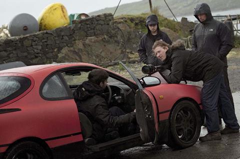 CALM WITH HORSES-BTS-Nick standing over the car_Credit Martin Maguire