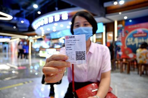 Lady with cinema ticket Nanning, Guangxi Zhuang autonomous region, July 2020_Credit Imaginechina Limited-Alamy